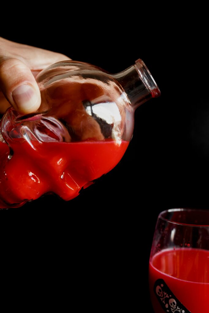 Halloween skull glass with wine pouring